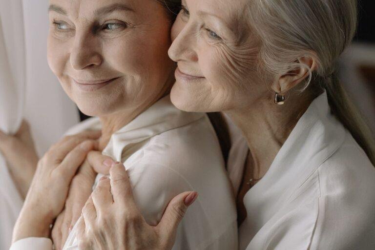 Elderly women sharing a tender moment, reflecting love and togetherness.